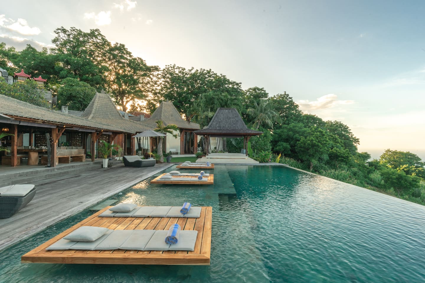 The villa’s pool and floating loungers above the sea