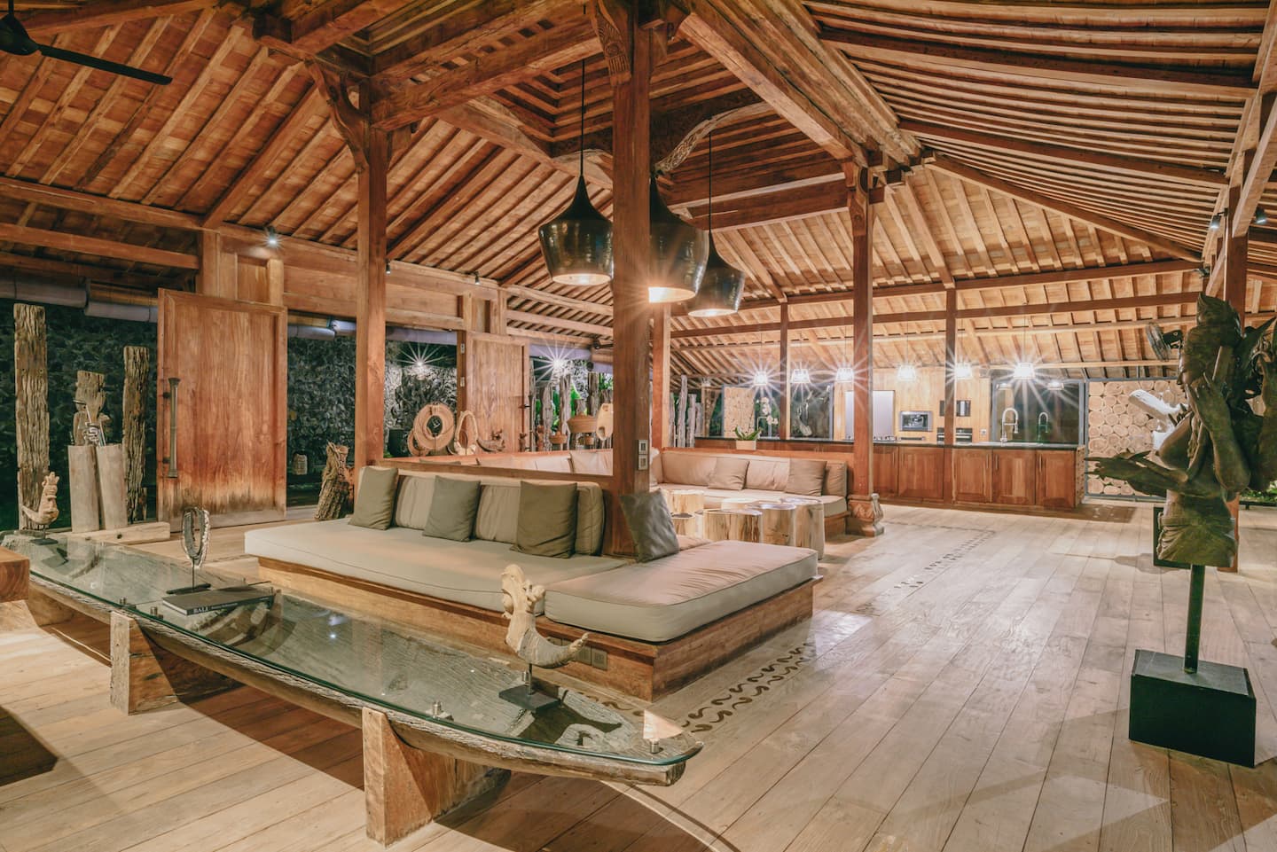 Carved wooden joglo living pavilion with open garden views